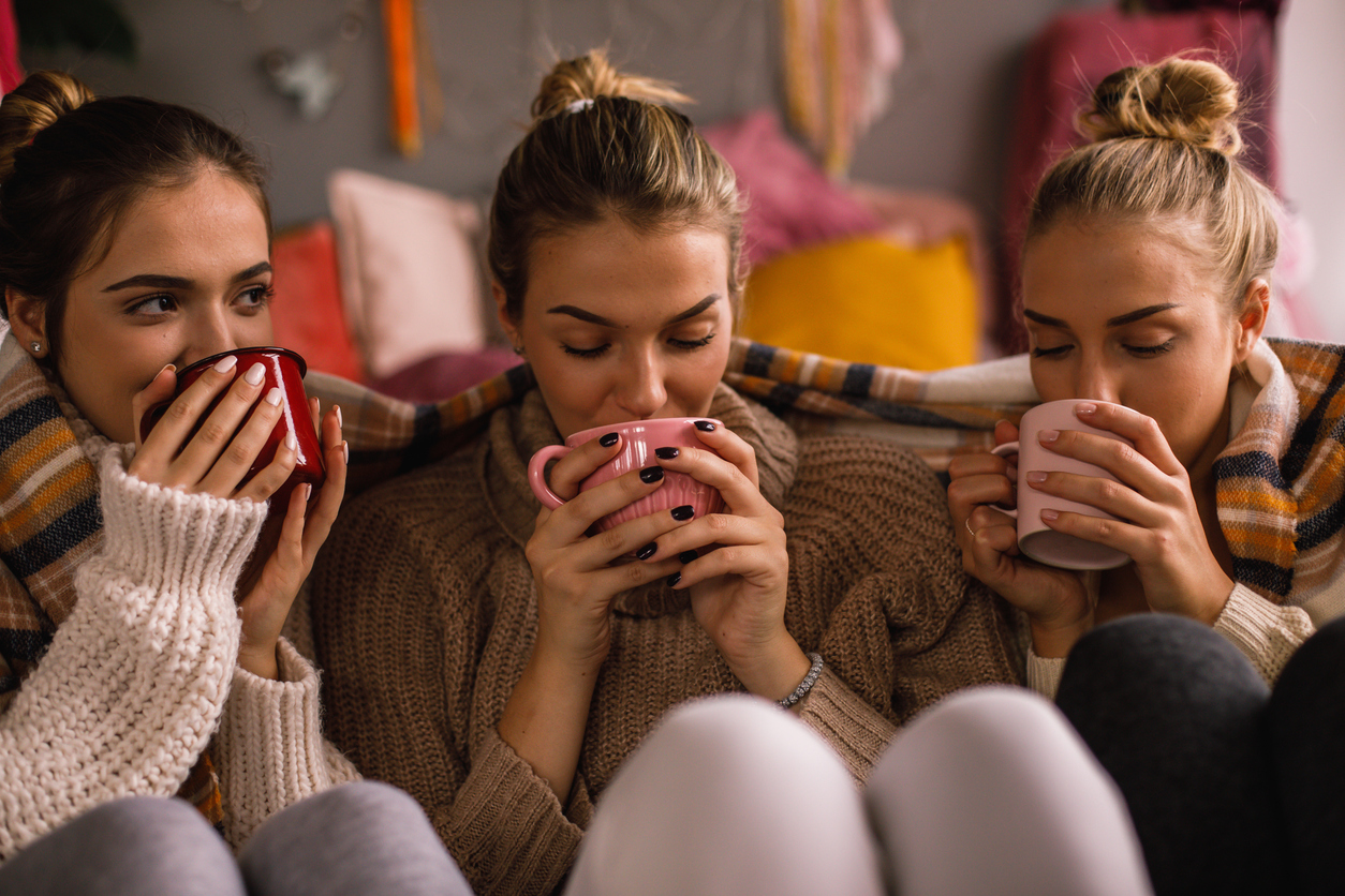 Hot cocoa with CBD oil - A group of female friends drinking hot cocoa at home during autumn.