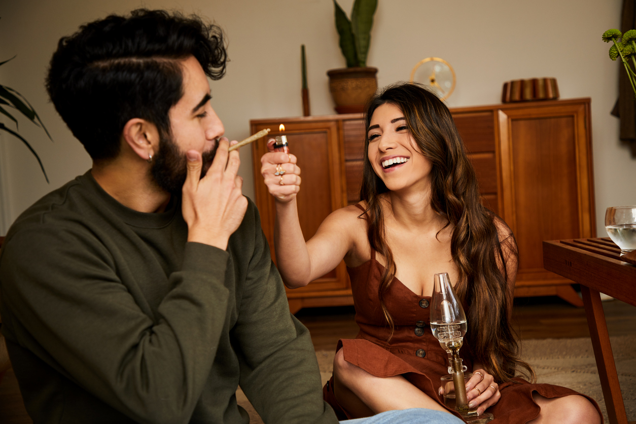 Valentine’s Day gift ideas - A couple at home sharing a pre-rolled cannabis.